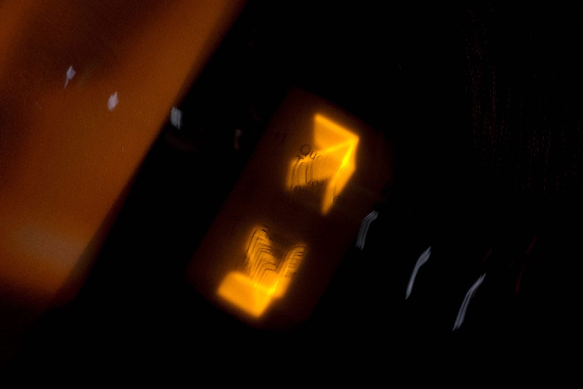 Glowing amber lantern light in darkness